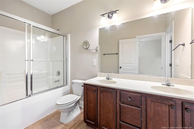 427 Georgetown Cir, Fayetteville, NC 28314 - bathroom featuring toilet, double vanity, shower / bath combination with glass door, and tile patterned floors