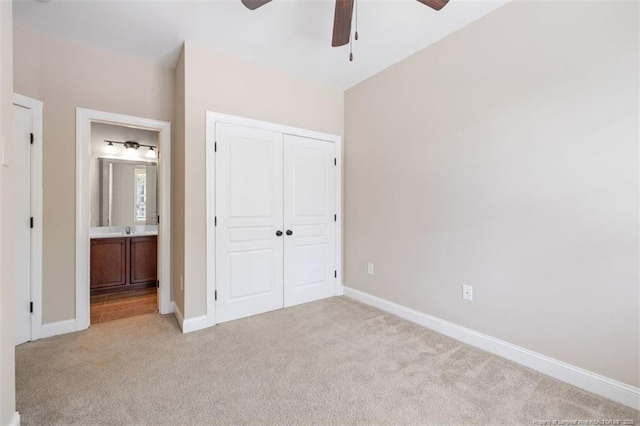 427 Georgetown Cir, Fayetteville, NC 28314 - unfurnished bedroom featuring light carpet, a closet, baseboards, and a ceiling fan