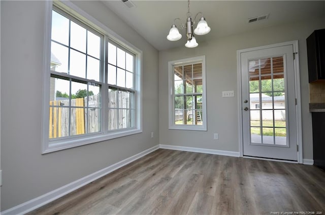 479 Broad Dr, Raeford, NC 28376 - unfurnished dining area with a chandelier, wood finished floors, and baseboards
