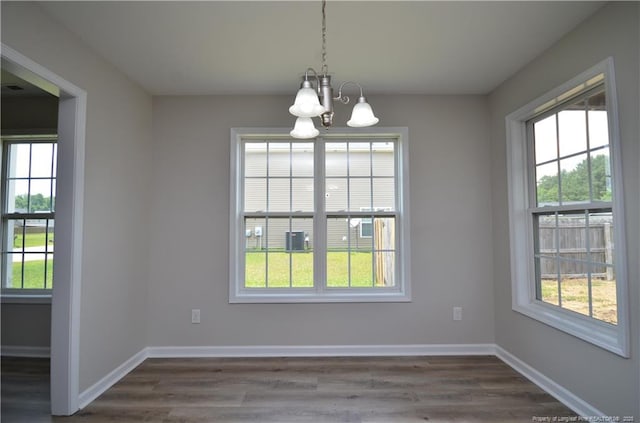 479 Broad Dr, Raeford, NC 28376 - unfurnished dining area with a chandelier, dark wood-style flooring, and baseboards