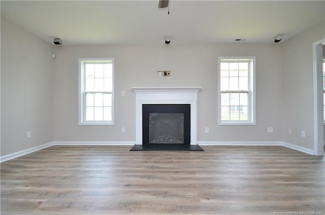 479 Broad Dr, Raeford, NC 28376 - unfurnished living room featuring plenty of natural light, wood finished floors, and baseboards