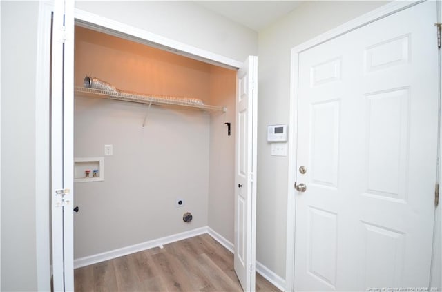 479 Broad Dr, Raeford, NC 28376 - laundry room featuring electric dryer hookup, wood finished floors, hookup for a washing machine, and baseboards