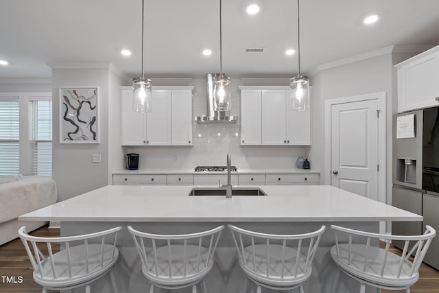 8415 Zinc Autumn Path, Raleigh, NC 27615 - kitchen with wall chimney range hood, crown molding, a sink, a breakfast bar area, and tasteful backsplash