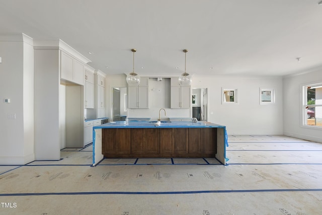 1225 Dixie Trl, Raleigh, NC 27607 - kitchen with white cabinetry, a spacious island, crown molding, hanging light fixtures, and recessed lighting