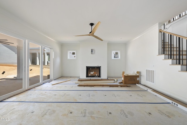 1225 Dixie Trl, Raleigh, NC 27607 - living room featuring a ceiling fan, a fireplace, crown molding, stairway, and heating unit