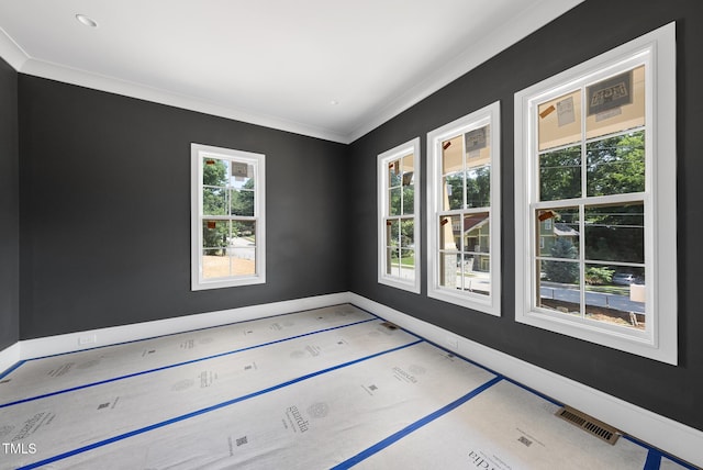 1225 Dixie Trl, Raleigh, NC 27607 - spare room featuring ornamental molding and baseboards