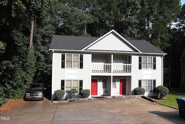 2204 Caroline Dr, Durham, NC 27705 - view of front of property with a balcony, a porch, driveway, and a shingled roof