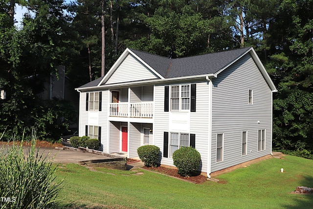 2204 Caroline Dr, Durham, NC 27705 - view of front of home featuring a front yard, a balcony, a patio area, and a shingled roof
