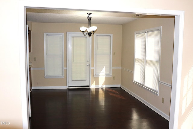 2204 Caroline Dr, Durham, NC 27705 - unfurnished dining area with a chandelier and dark wood-type flooring