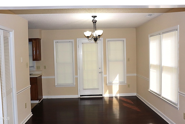 2204 Caroline Dr, Durham, NC 27705 - unfurnished dining area featuring a chandelier and dark wood-style flooring