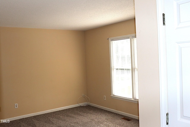 2204 Caroline Dr, Durham, NC 27705 - carpeted spare room with a textured ceiling and baseboards