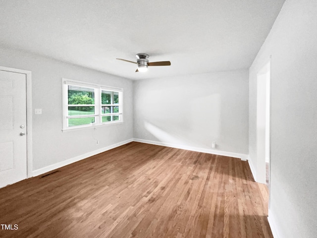 1311 Meadow Ln, Chapel Hill, NC 27516 - spare room featuring wood finished floors, a ceiling fan, and baseboards