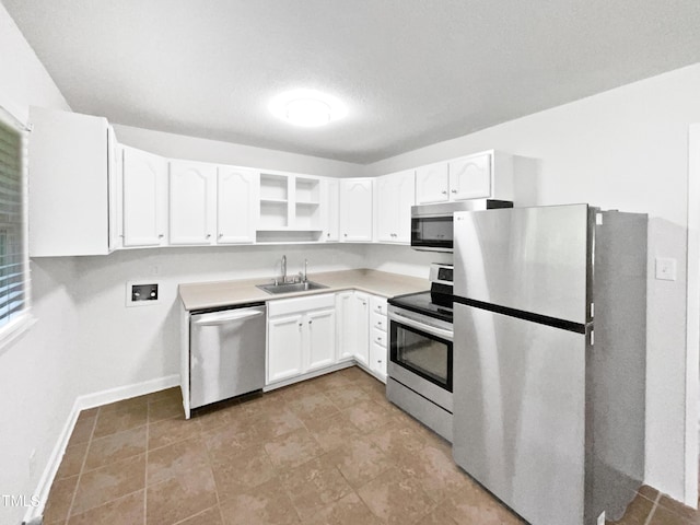 1311 Meadow Ln, Chapel Hill, NC 27516 - kitchen featuring appliances with stainless steel finishes, a sink, white cabinetry, light countertops, and baseboards