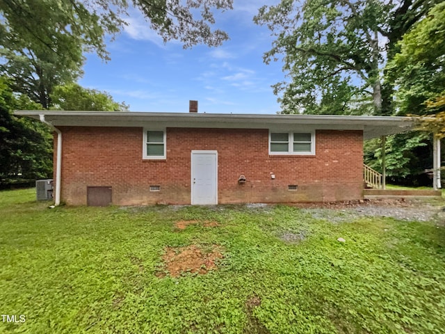 1311 Meadow Ln, Chapel Hill, NC 27516 - back of property with crawl space, a lawn, cooling unit, and brick siding