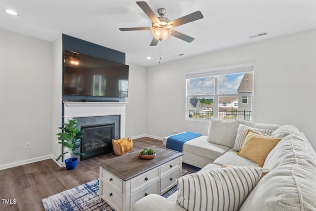 509 Rain Drizzle Ct, Wake Forest, NC 27587 - living room with dark wood-style flooring, ceiling fan, a tiled fireplace, and recessed lighting