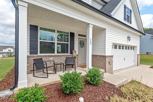 509 Rain Drizzle Ct, Wake Forest, NC 27587 - entrance to property with a porch, brick siding, a garage, driveway, and board and batten siding
