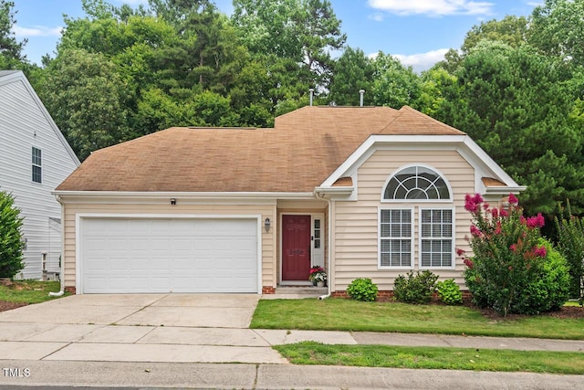 1406 Pebble Creek Xing, Durham, NC 27713 - view of front of property featuring concrete driveway, an attached garage, and roof with shingles