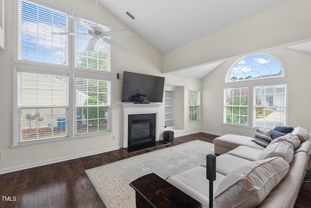1406 Pebble Creek Xing, Durham, NC 27713 - living area with healthy amount of natural light, high vaulted ceiling, a glass covered fireplace, and dark wood-type flooring