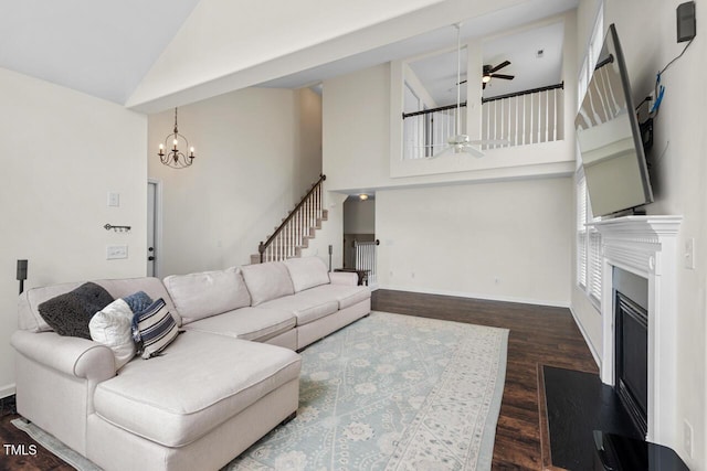 1406 Pebble Creek Xing, Durham, NC 27713 - living room with high vaulted ceiling, ceiling fan, wood finished floors, a glass covered fireplace, and stairs