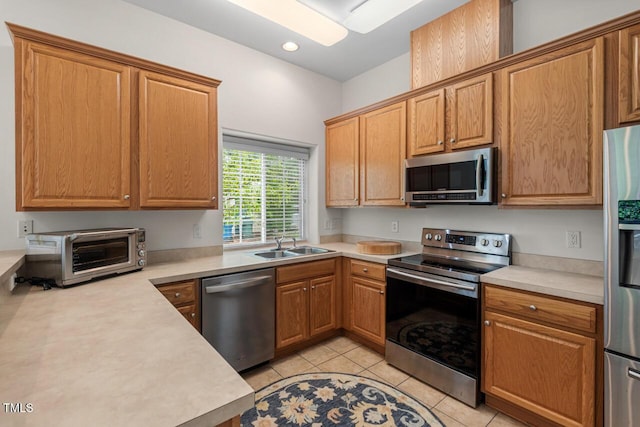 1406 Pebble Creek Xing, Durham, NC 27713 - kitchen featuring appliances with stainless steel finishes, light countertops, light tile patterned floors, and recessed lighting