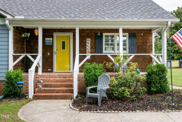 1008 Catsby Cir, Raleigh, NC 27603 - property entrance with a shingled roof and a porch