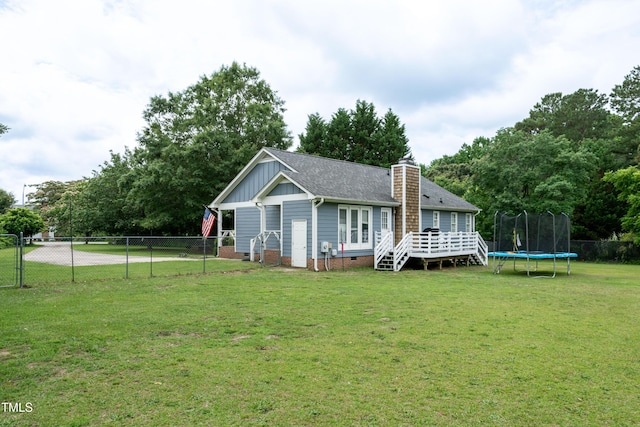 1008 Catsby Cir, Raleigh, NC 27603 - back of property featuring a trampoline, a fenced backyard, board and batten siding, a deck, and a chimney