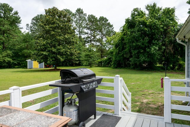 1008 Catsby Cir, Raleigh, NC 27603 - deck with a lawn, a shed, area for grilling, and view of scattered trees