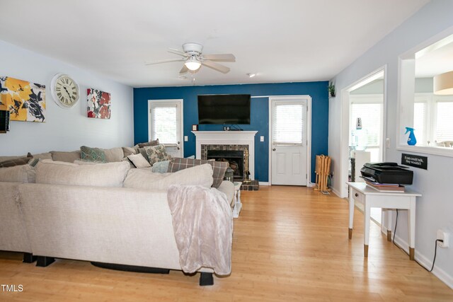 1008 Catsby Cir, Raleigh, NC 27603 - living area featuring ceiling fan, light wood-style floors, and a premium fireplace