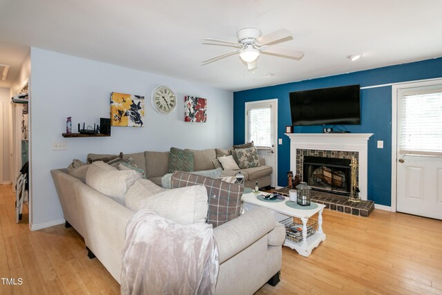 1008 Catsby Cir, Raleigh, NC 27603 - living room with a ceiling fan, a tile fireplace, and wood-type flooring