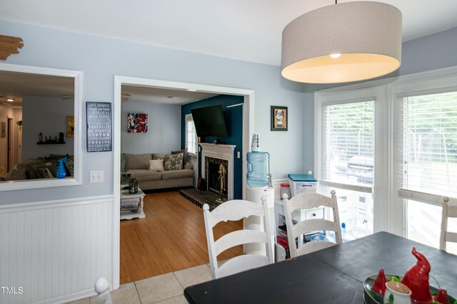 1008 Catsby Cir, Raleigh, NC 27603 - tiled dining room featuring wainscoting and a fireplace with raised hearth