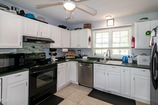 1008 Catsby Cir, Raleigh, NC 27603 - kitchen featuring black appliances, under cabinet range hood, dark countertops, light tile patterned floors, and white cabinetry