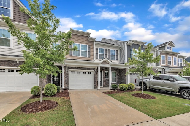 656 Barneswyck Dr, Fuquay Varina, NC 27526 - view of front of home featuring a garage, driveway, a front yard, and stone siding