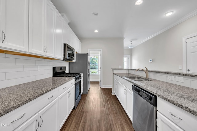 656 Barneswyck Dr, Fuquay Varina, NC 27526 - kitchen featuring stainless steel appliances, white cabinets, stone counters, dark wood-style floors, and recessed lighting
