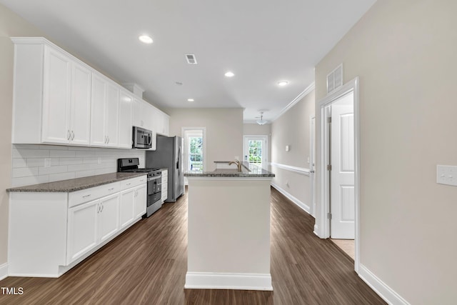 656 Barneswyck Dr, Fuquay Varina, NC 27526 - kitchen featuring stainless steel appliances, an island with sink, white cabinets, and recessed lighting