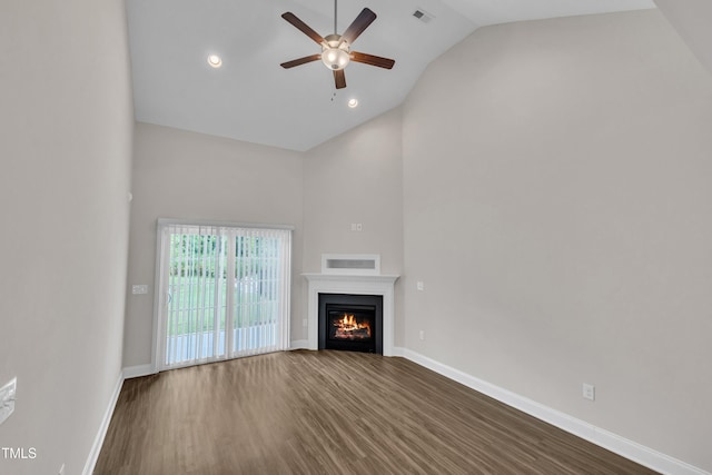 656 Barneswyck Dr, Fuquay Varina, NC 27526 - unfurnished living room with ceiling fan, dark wood-type flooring, high vaulted ceiling, a warm lit fireplace, and recessed lighting