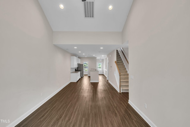 656 Barneswyck Dr, Fuquay Varina, NC 27526 - unfurnished living room featuring stairs, dark wood-style flooring, and recessed lighting