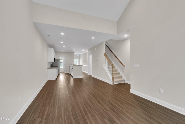 656 Barneswyck Dr, Fuquay Varina, NC 27526 - unfurnished living room with dark wood-style floors, stairway, and recessed lighting