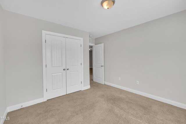 656 Barneswyck Dr, Fuquay Varina, NC 27526 - unfurnished bedroom with light colored carpet and a closet