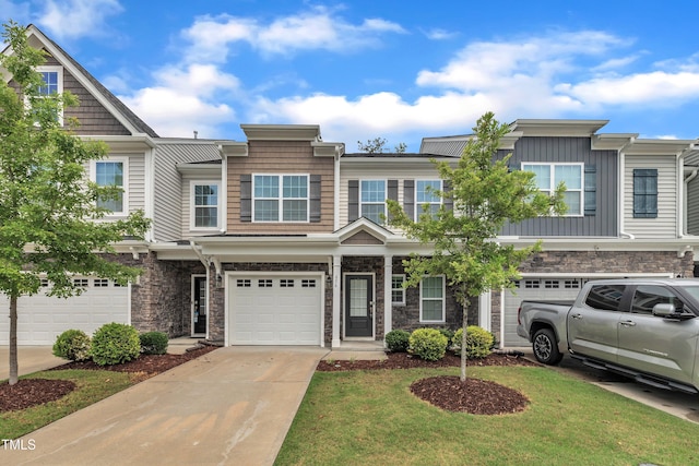 656 Barneswyck Dr, Fuquay Varina, NC 27526 - view of front of home with a garage, concrete driveway, stone siding, board and batten siding, and a front lawn