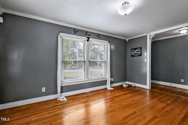 106 Grace Dr NW, Wilson, NC 27896 - spare room featuring ornamental molding, wood finished floors, baseboards, and a textured ceiling