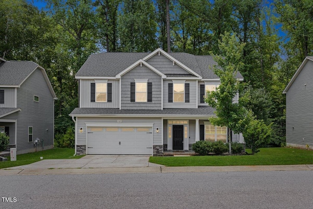 509 Holden Forest Dr, Youngsville, NC 27596 - craftsman-style house featuring driveway, stone siding, a garage, and a front lawn