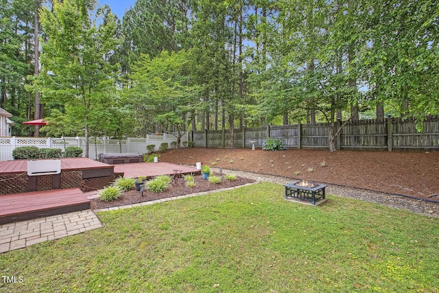 2311 Woodwyck Way, Raleigh, NC 27604 - fenced backyard with a wooden deck and a fire pit