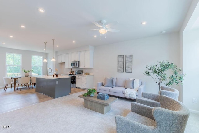 1359 Chowan Ave, Durham, NC 27713 - living room featuring recessed lighting, a ceiling fan, light wood-type flooring, and light carpet