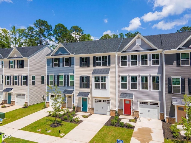 1359 Chowan Ave, Durham, NC 27713 - townhome / multi-family property with driveway, an attached garage, stone siding, and a residential view