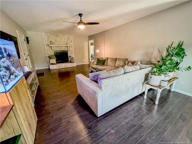 5692 Archer Rd, Hope Mills, NC 28348 - living area featuring a ceiling fan, dark wood-style flooring, and a stone fireplace