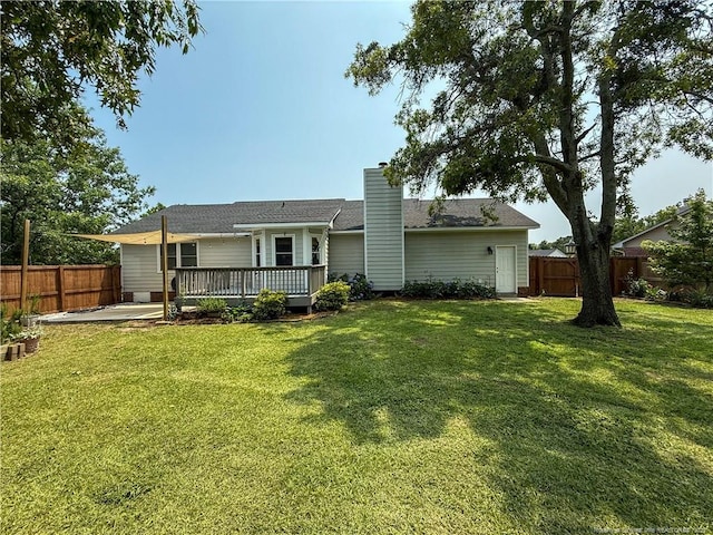 5692 Archer Rd, Hope Mills, NC 28348 - back of property featuring a fenced backyard, a wooden deck, and a chimney