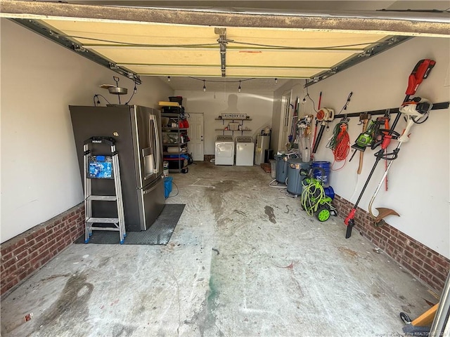 5692 Archer Rd, Hope Mills, NC 28348 - garage featuring washing machine and dryer, stainless steel refrigerator with ice dispenser, and gas water heater