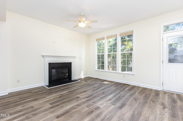 1613 Patterson Grove Rd, Apex, NC 27502 - unfurnished living room with plenty of natural light, wood finished floors, ceiling fan, and baseboards