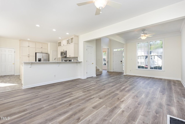 1613 Patterson Grove Rd, Apex, NC 27502 - unfurnished living room featuring recessed lighting, healthy amount of natural light, ceiling fan, baseboards, and crown molding