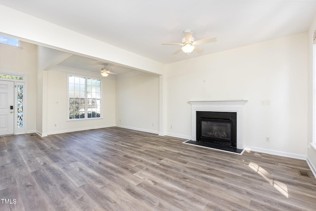 1613 Patterson Grove Rd, Apex, NC 27502 - unfurnished living room with ceiling fan, wood finished floors, baseboards, and a glass covered fireplace